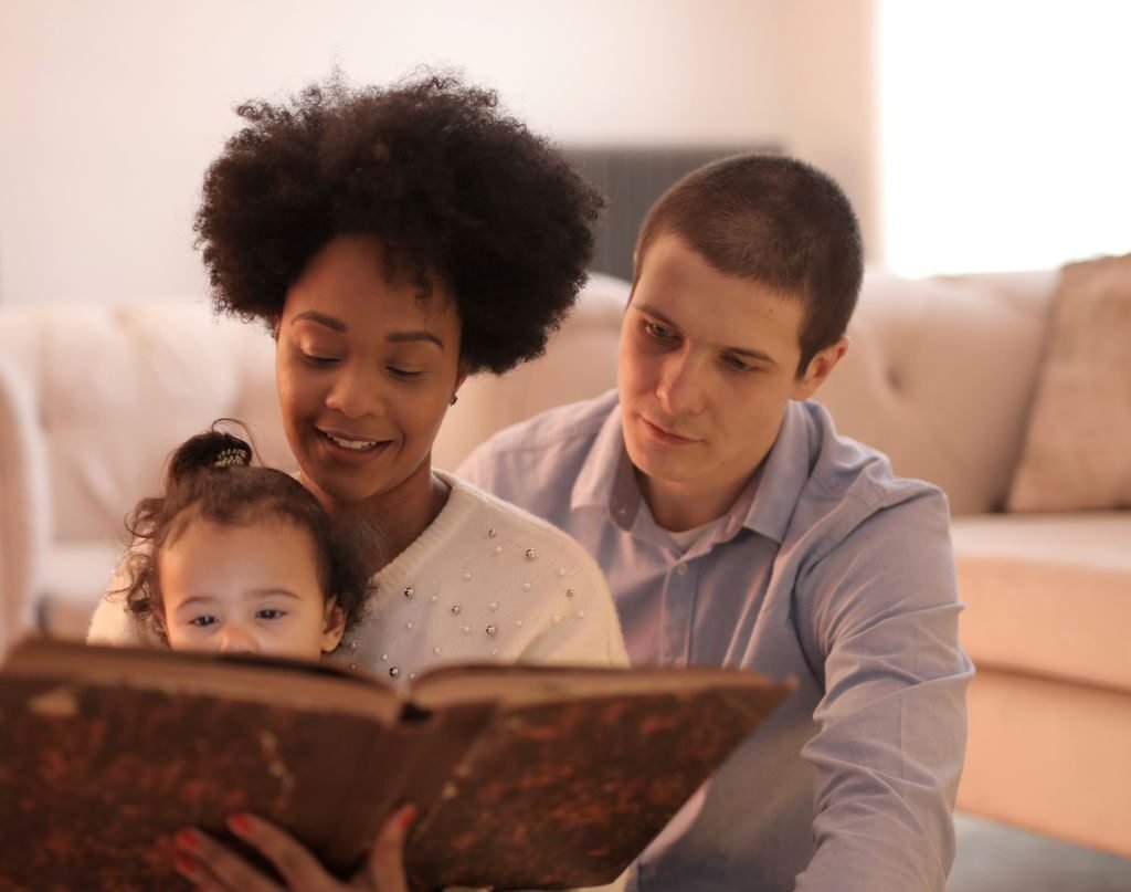 Family reading together at home as part of a daily learning routine