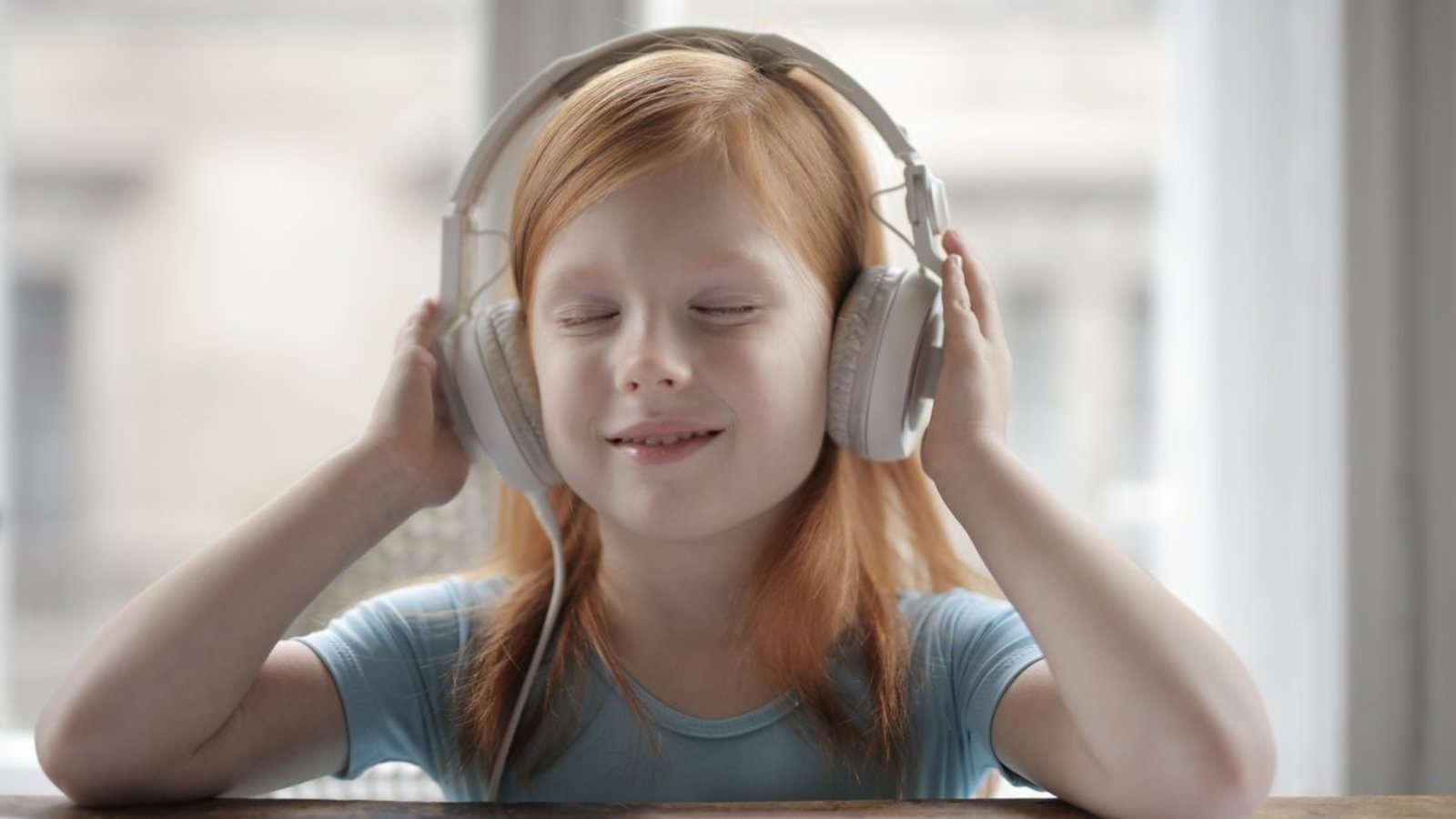 Child wearing headphones for a live one-on-one online Quran class
