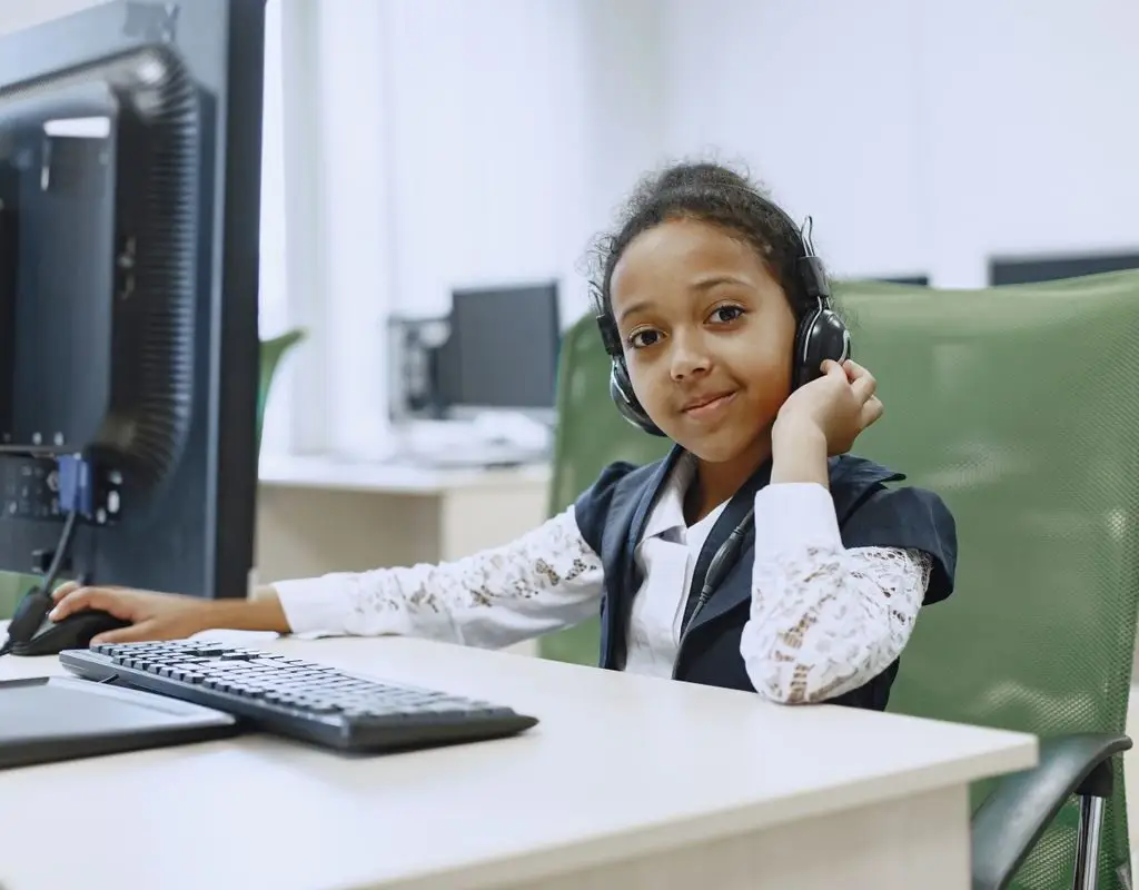 Child wearing a headset during a live online Quran class